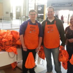 Pettit Kohn employees distributing WOA goodie bags to active-duty service members 12/20/14